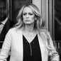 Black-and-white photo of Stormy Daniels leaving a court room