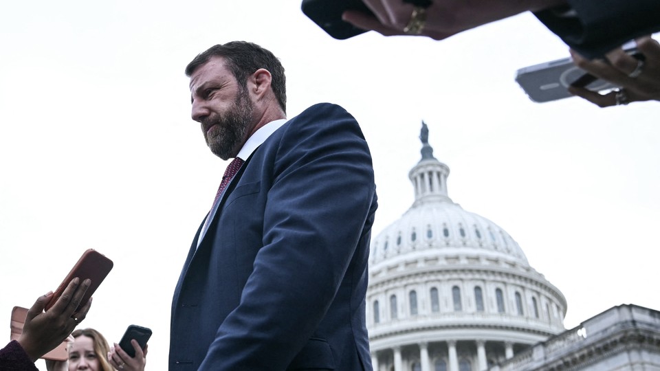 Markwayne Mullin in front of the Capitol building surrounding by reporters
