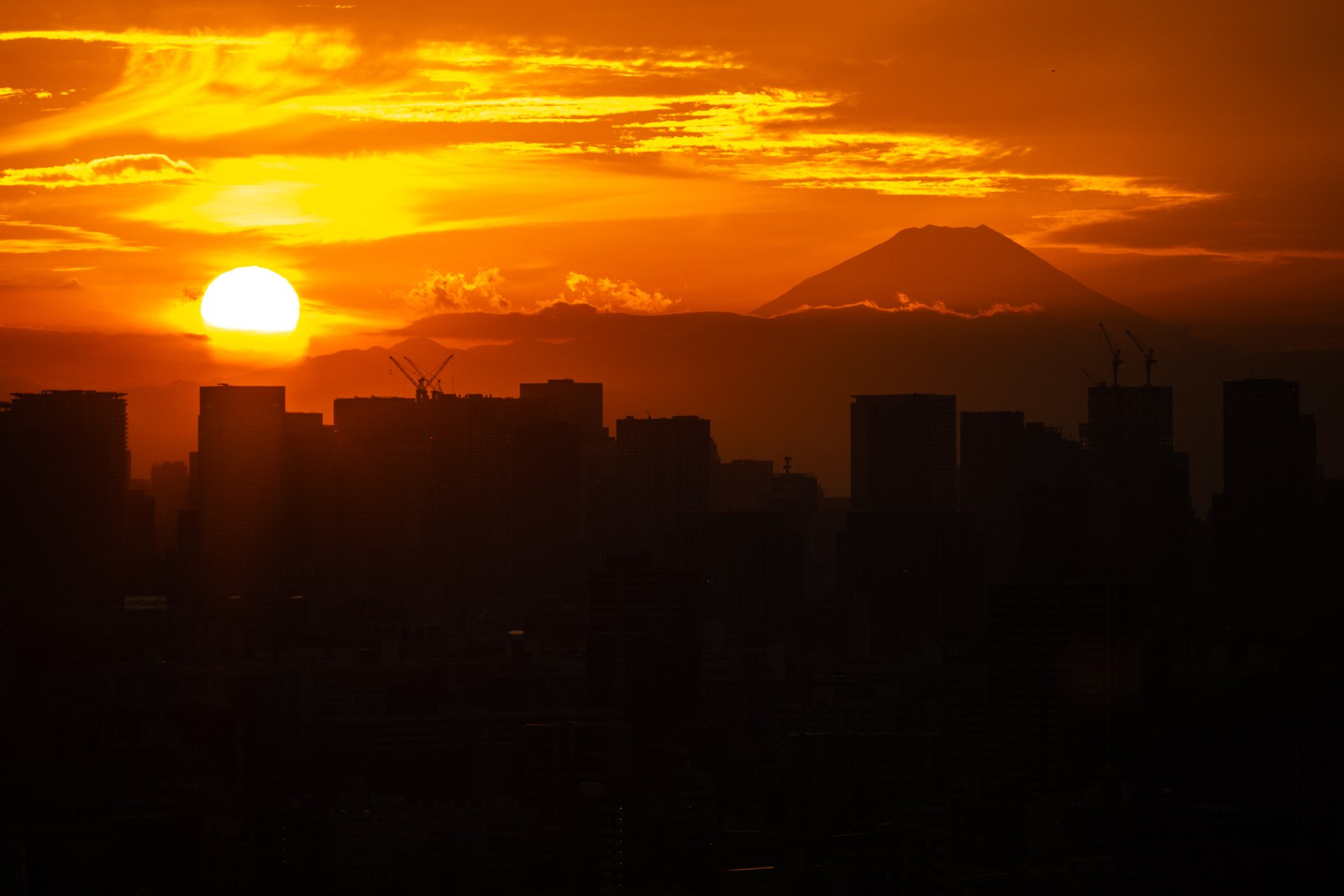 A sunset, seen from Tokyo, with Mount Fuji in the distance.