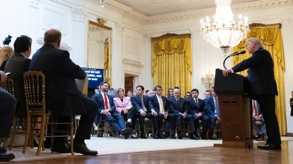 A photo of President Trump delivering a White House speech to an audience.