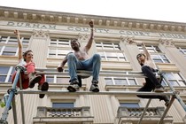 Protestors sit on scaffolding outside the old Durham County courthouse.