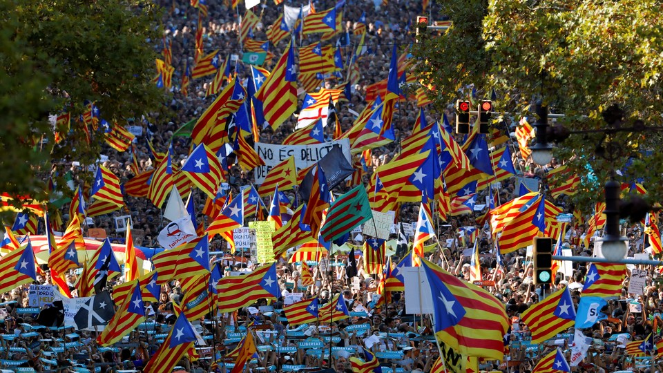 Pro-independence protesters wave Catalan flags