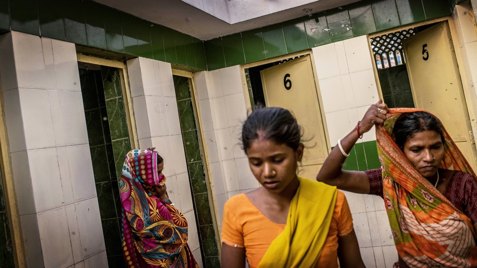 Women waiting to use a community toilet in India