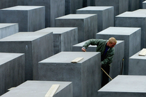A worker at the Memorial to the Murdered Jews of Europe cleans the memorial grounds.