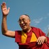 The Dalai Lama waves in front of the Capitol