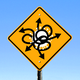 A road sign showing a virus with arrows coming out of it in all directions