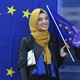 A Muslim woman holds a European flag during a pro-EU demonstration.