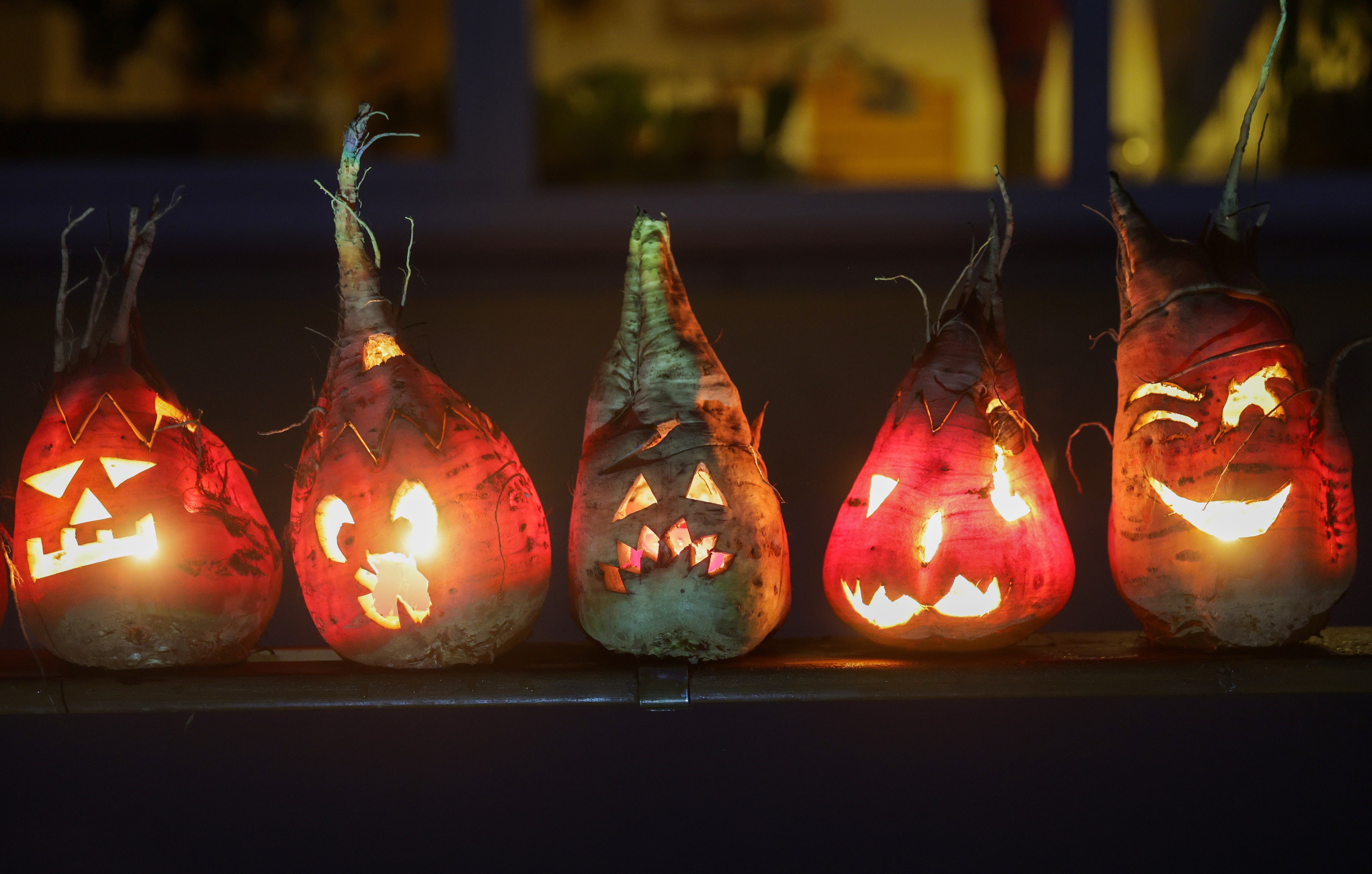 Five beets, carved like Jack-o'-lanterns
