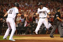 The Arizona Diamondbacks second baseman Daniel Descalso celebrates with the third baseman Jake Lamb after scoring runs in the 2017 National League wildcard playoff baseball game against the Colorado Rockies at Chase Field. 