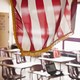 An American flag hangs above a classroom