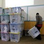 An election official from the Independent Electoral and Boundaries Commission arranges ballot boxes inside the Jamuhuri High School tallying center in Nairobi, Kenya, on August 9.
