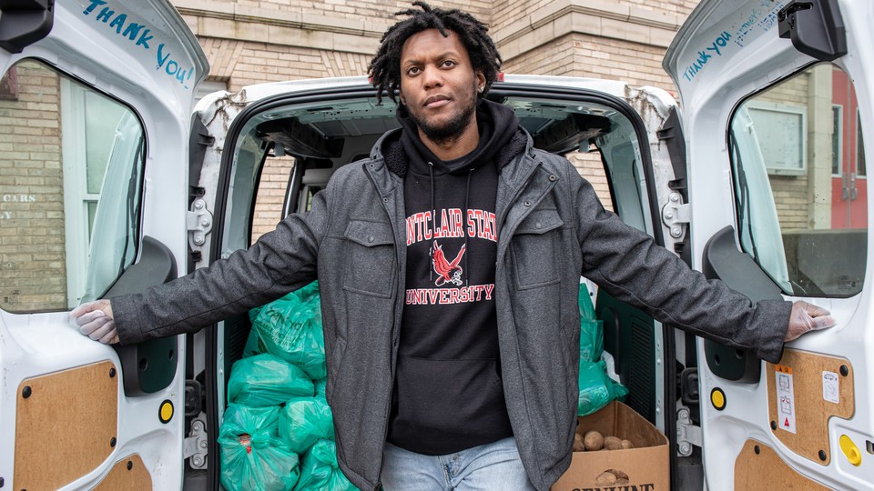 Jamel Dobbins, 31, preps and h​ands out free food at Hillside​ Elementary School, in Montclair, New Jersey.