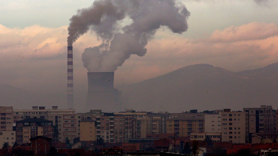 A coal-fired power plant in Kosovo release smoke into the sky.