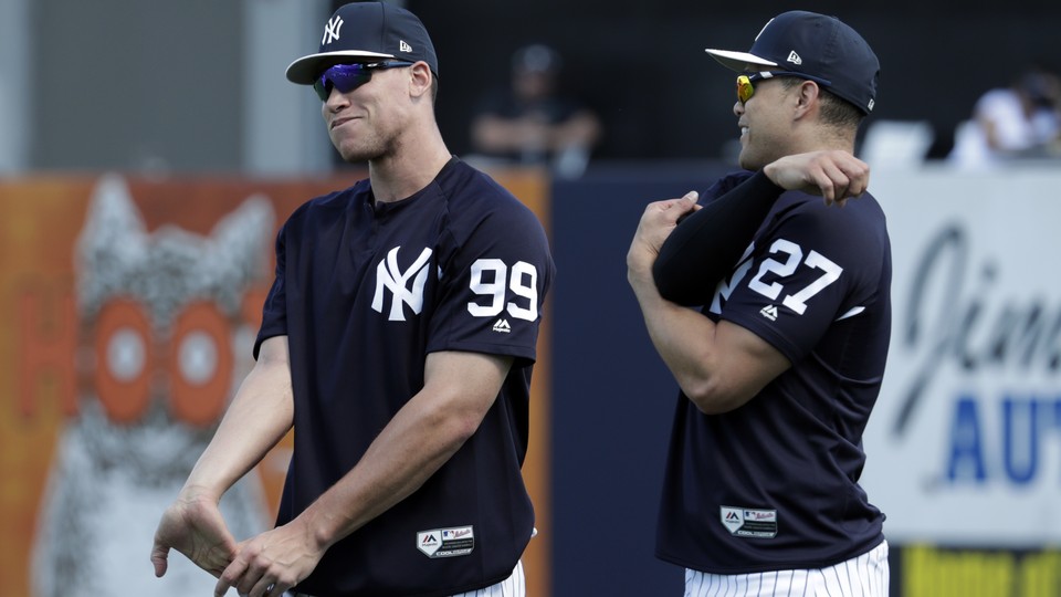 New York Yankees' Aaron Judge, left, and Giancarlo Stanton stretch at baseball spring training camp