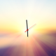 a clock almost at 6 a.m., overlaid onto a hazy sunrise