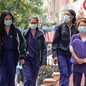 Medical workers walk near NYU Langone Health hospital in New York City on September 29, 2020