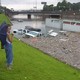 Stranded motorists look over a flooded I-45 North near downtown Houston after tropical storm Allison, in 2001.