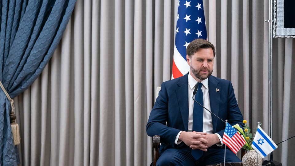 J.D. Vance sits in front of an American flag with small American and Israeli flags in front of him.