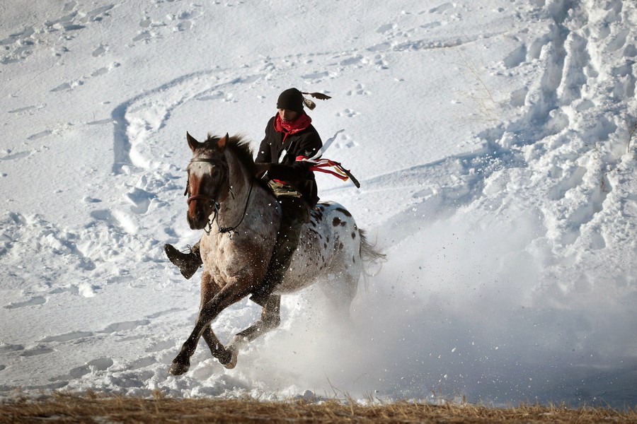 A Native American activist rides down from a ridge that overlooks Oceti Sakowin Camp on the edge of the Standing Rock Sioux Reservation on December 4, 2016.