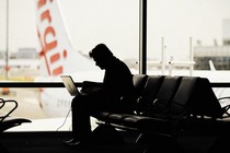 Person working on their laptop at the airport