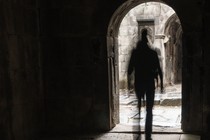 man walking out of a church door