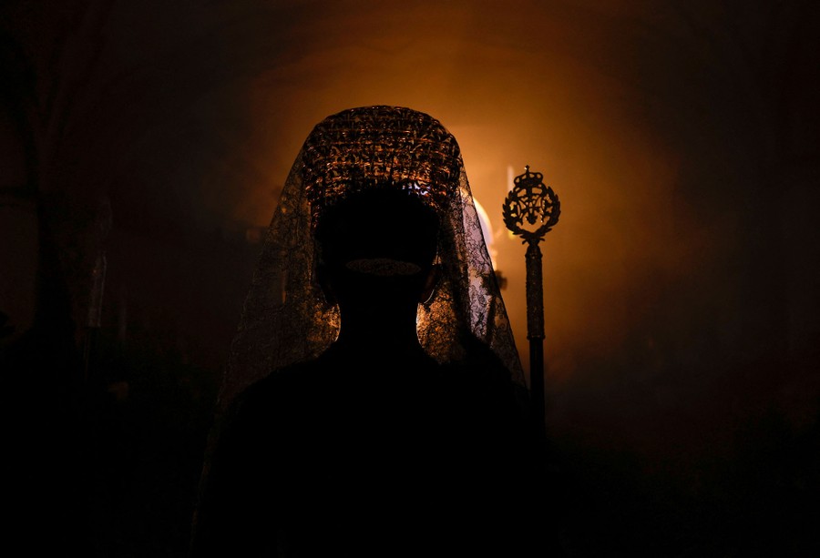 A backlit view of a woman wearing a traditional veil