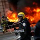 Firefighters arrive as police stand guard in front of a limousine which was set ablaze during a protest against President Donald Trump on January 20, 2017, in Washington, D.C.