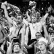 Black-and-white photo of Denmark’s fans celebrate the team’s victory after defeating Russia in a match