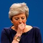 Prime Minister Theresa May coughs as she addresses the Conservative Party conference.