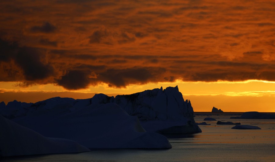 A view of floating icebergs at sunset
