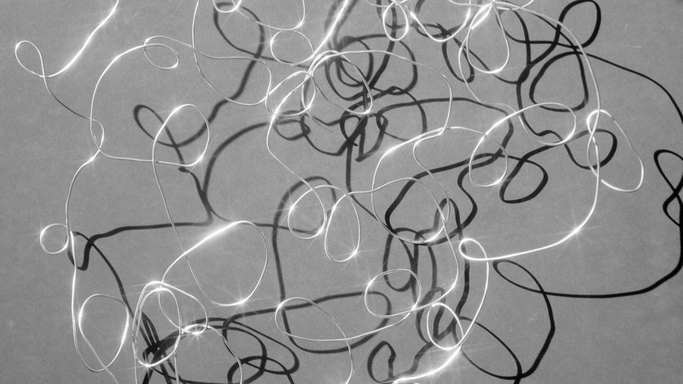 A twisted wire casts a shadow in harsh light