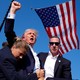 Donald Trump with blood on his face, raising his fist, after an assassination attempt at his rally