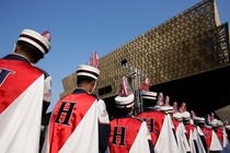 The backs of musicians in front of the grand museum