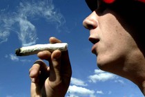 Picture of a person smoking a weed pipe.