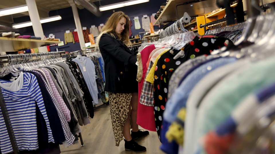 A Millennial shops at a used-clothing store.