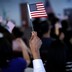 A new citizen waves an American flag during a naturalization ceremony.