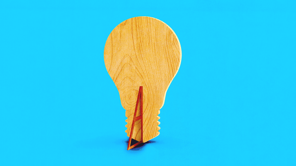 An illustration of a flat piece of wood that is shaped like a lightbulb and propped up by a wedge