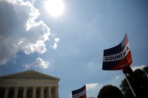 A protester holds a sign outside the U.S. Supreme Court today, when the court ruled that President Donald Trump's administration did not give an adequate explanation for its plan to add a citizenship question to the 2020 census.