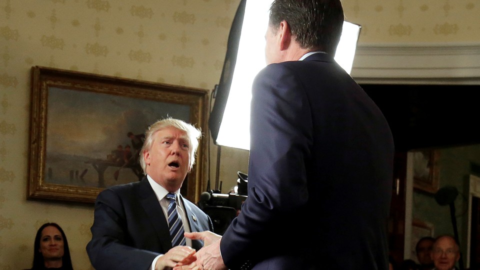 President Trump greets FBI Director James Comey at a January 22 reception.