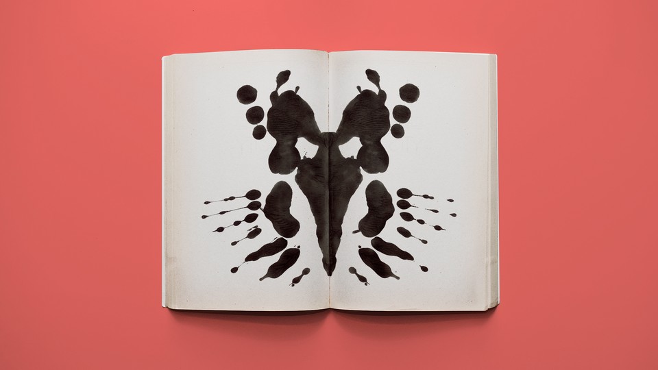 An ink blot in the middle of the pages of an open book.