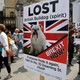 People walk past pro-Brexit placards in central London.