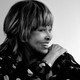 A black-and-white portrait of Tina Turner