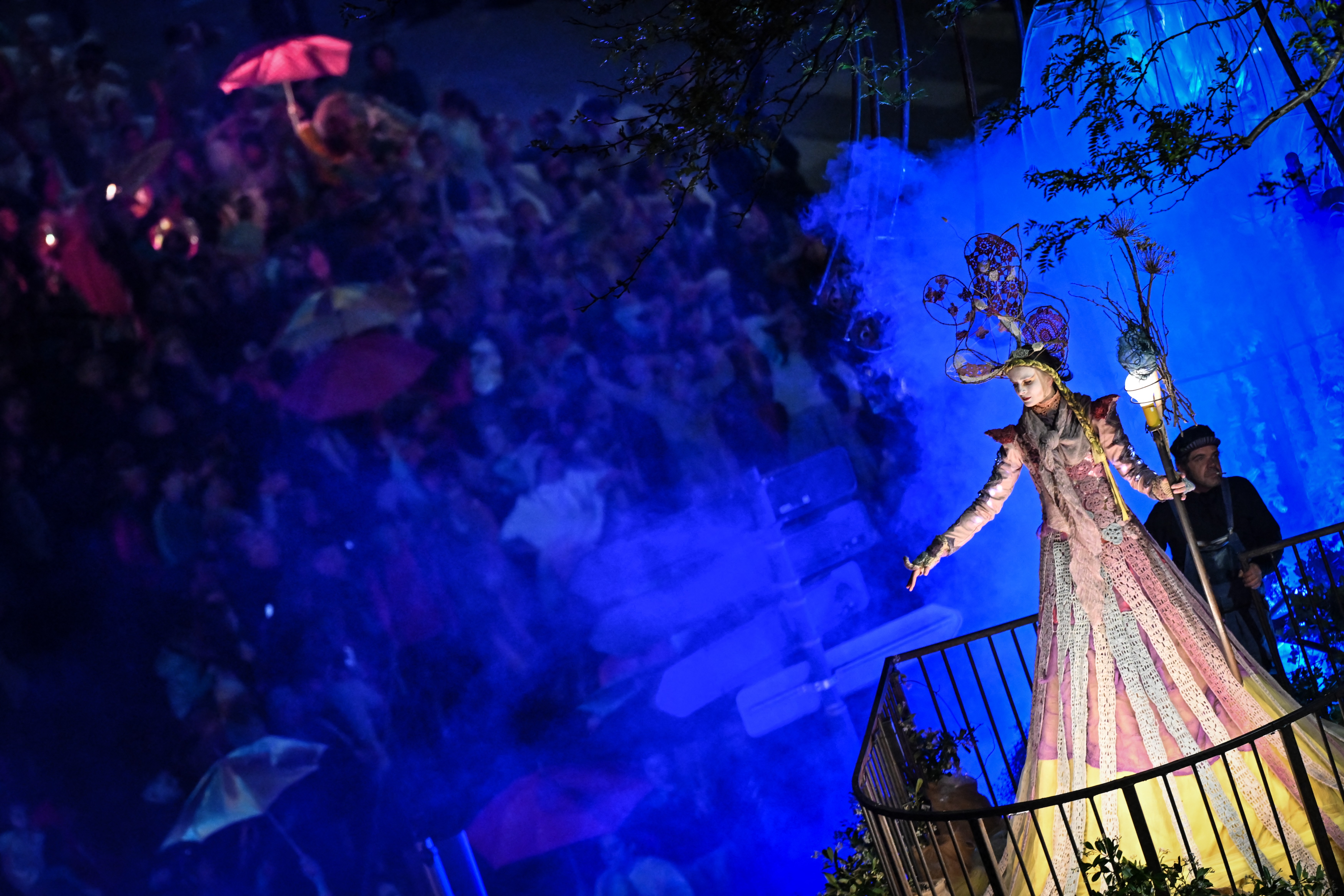 A costumed performer rides atop a parade float.