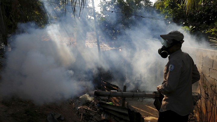 A health worker fumigates a neighborhood on the outskirts of Panama City