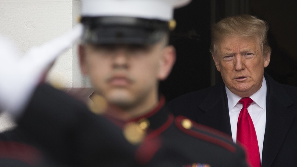 Donald Trump stands behind US Marines who are saluting
