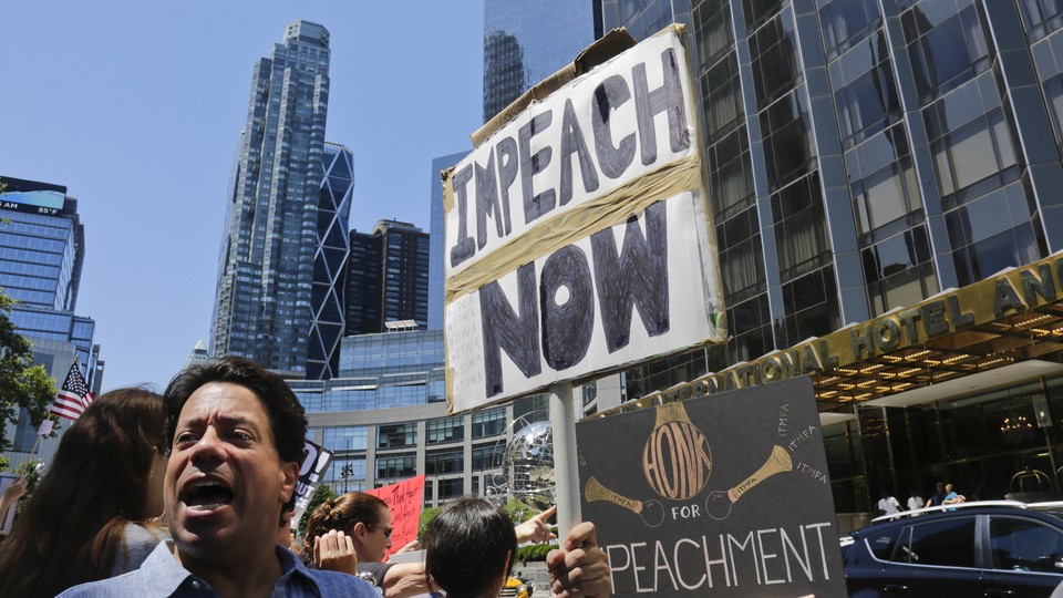 Protesters rally outside a Trump hotel to call for the impeachment of President Trump, in New York.