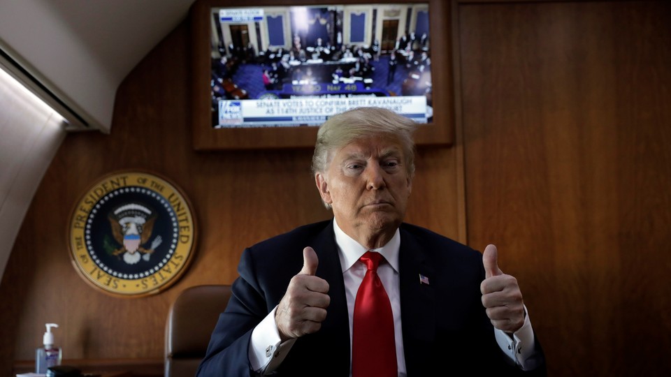 President Trump gives a thumbs-up sign from Air Force One on Saturday, just after Judge Kavanaugh was confirmed to the Supreme Court.