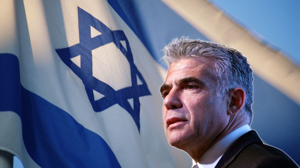 Israeli foreign minister Yair Lapid against an Israeli flag background
