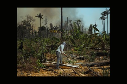 BRAZIL. 2019. Edmar, a worker on a small farm in the Victoria settlement, clears away brush in an effort to contain fires.