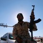 A member of Libyan forces loyal to eastern commander Khalifa Haftar holds a weapon as he sits on a car in front of the gate at Zueitina oil terminal, west of Benghazi, Libya, on September 14, 2016. 